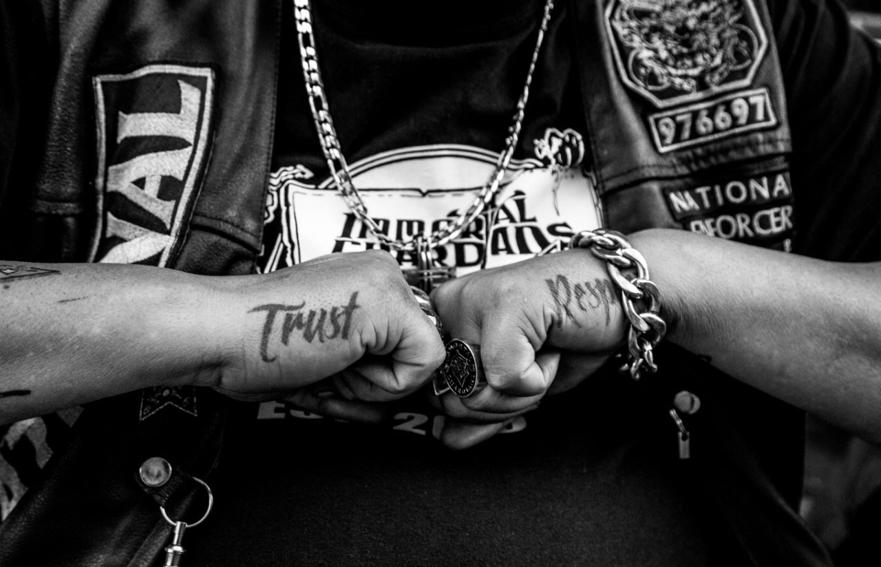 Trust and Respect tattoos on the hands of the Immortal Guardians MC National Enforcer